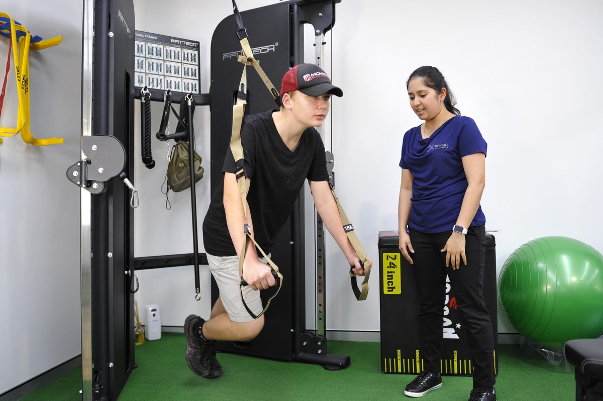 Physiotherapist guiding a client through functional rehabilitation