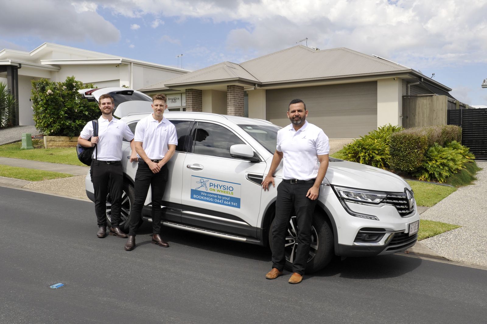 Physio on Wheels clinicians beside their mobile service vehicle